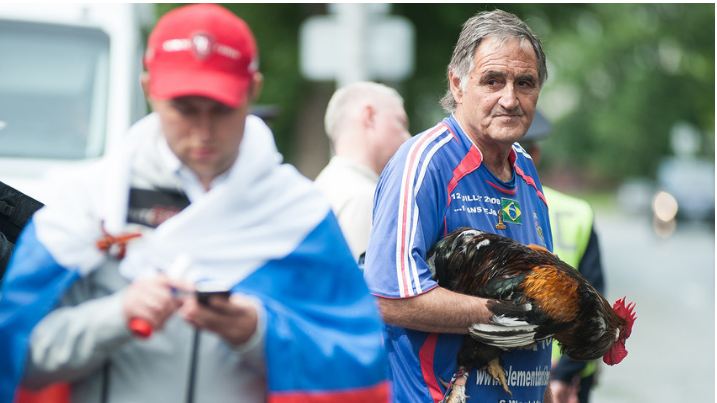 Des supporters accueillent les Bleus à Ekaterinbourg en compagnie d’un véritable coq